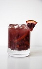 The Blood Orange Caipirinha drink recipe delivers on its name. A dark orange colored cocktail made from Leblon cachaca, blood orange, lime juice and sugar, and served in a rocks glass full of ice.